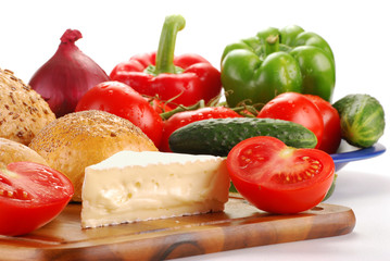 Composition with vegetables bread and cheese on breaboard