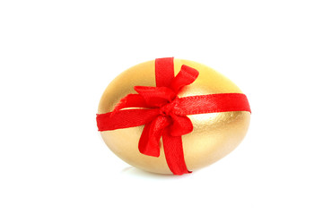 Golden egg with red stripe isolated on white