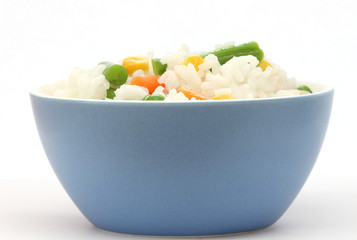 Blue bowl with cooked rice with mixed vegetable