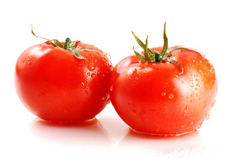 Two tomatoes isolated on white