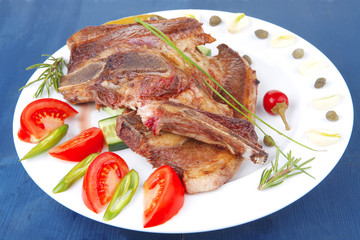 meat steak on white plate with green hot pepper