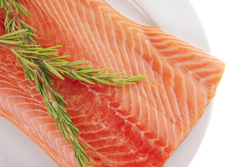 big salmon fillet on white with rosemary