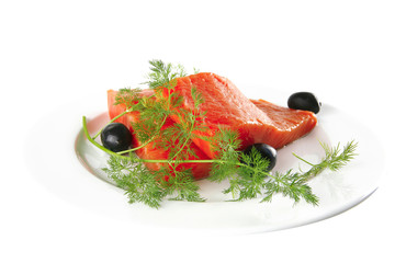 fresh smoked salmon on white plate with olives