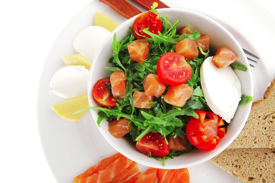salad with smoked salmon in white bowl
