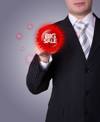 Man pressing BIG SALE button