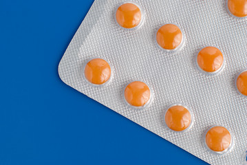 Close-up of a pack of orange pills