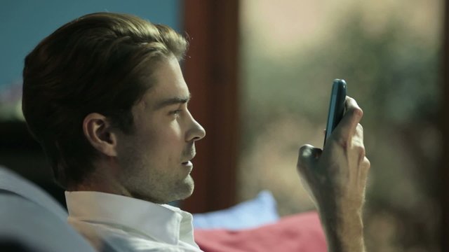 man typing sms on cellphone
