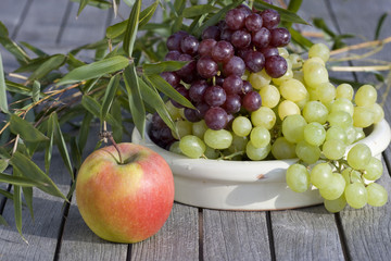 Naklejka na ściany i meble Fresh grapes and red apples outdoor