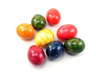 A selection of shiny painted easter eggs on a white background