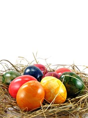 A selection of shiny easter eggs on a grass background