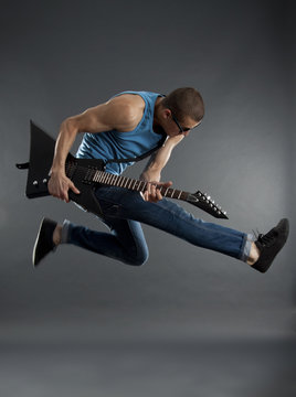 rock star jumping with guitar
