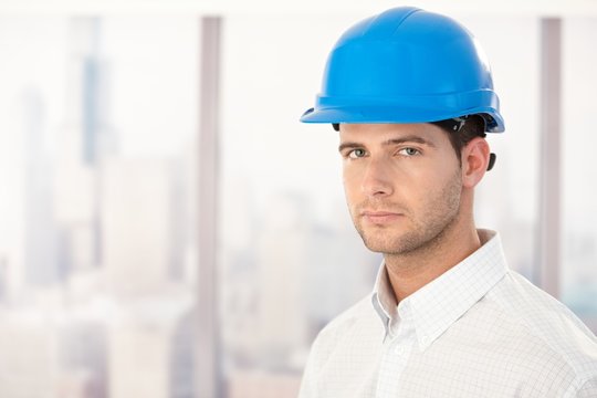 Handsome young engineer in hardhat