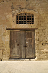 Fototapeta na wymiar Old wooden door in a stone wall