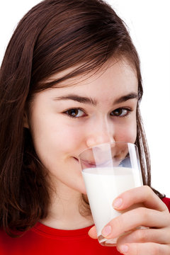 Girl holding glass of milk isolated on white background