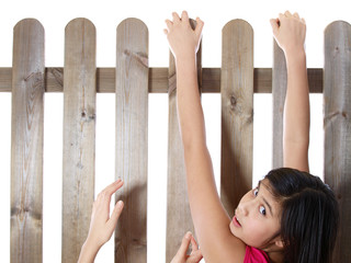 teenage girls climbing over the fence