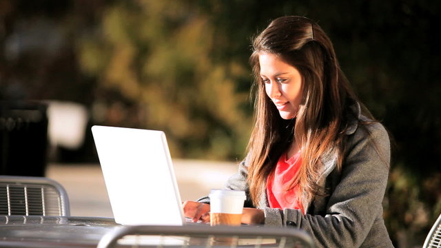 Female Student Outdoors with Laptop & Coffee