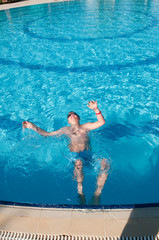 teenager swims in pool