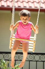 Happy young child on swing