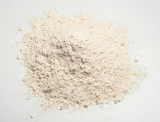 Wheat flour heap on a white background