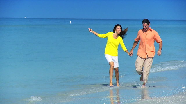 Young Couple Running Through the Sea filmed at 60FPS