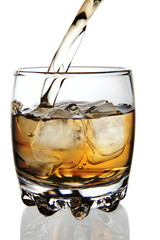 whiskey being poured into a glass