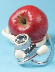 apple and stethoscope - focus in the middle
