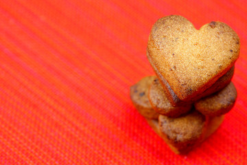 cookie  in the form of heart  in a plate  on a red background