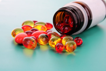 red capsules of vitamins on a blue background