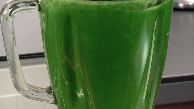 mixing fresh spinach leaves