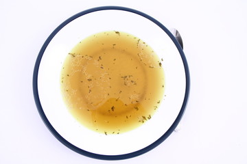 Chicken soup on a plate on white background