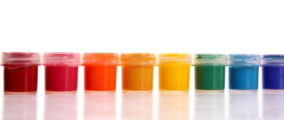 Raw of gouache cans and brushes isolated on white