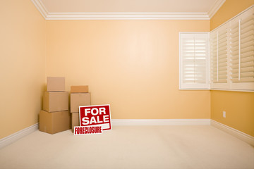 Boxes, Sale and Foreclosure Real Estate Signs in Empty Room