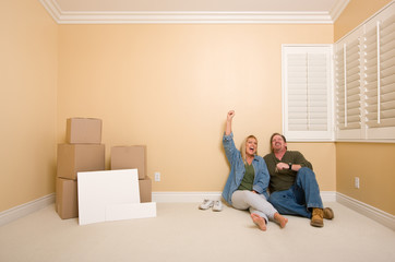 Couple on Floor Near Boxes and Blank Signs