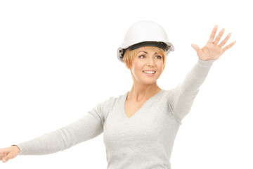 female contractor in helmet working with something imaginary