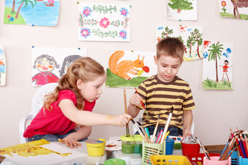 Children painting in play room.