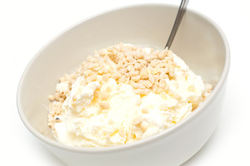 icecream with nuts tossed on top, against white background