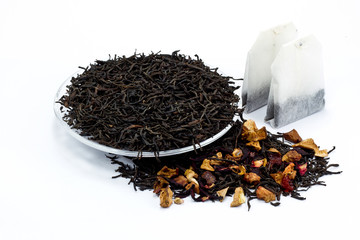 black tea leaves with dried fruit tea on white background