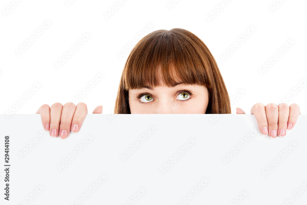 Wall mural pensive woman peeking over blank billboard