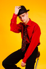 man in a hat on a yellow background