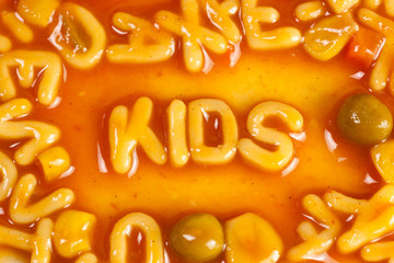 Alphabet shaped pasta forming the word KIDS in tomato sauce