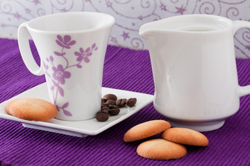 an elegant cup of coffee with milk and  biscuits