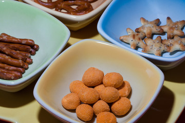 mixed snacks and appetizers divided by small trays