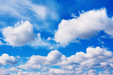 Background of blue sky with cumulus and fleecy clouds