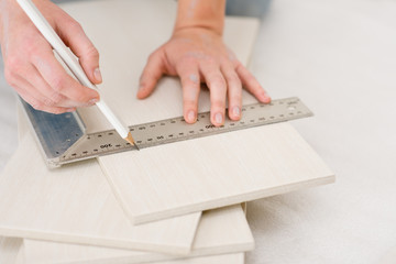 Home improvement - handywoman measuring tile