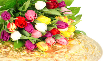Colorful tulips on golden plate
