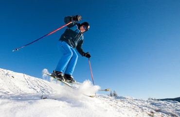 Fototapeta na wymiar Man practicing extreme ski on sunny day