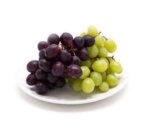 two bunches of grapes on a plate