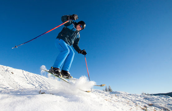 Man practicing extreme ski on sunny day