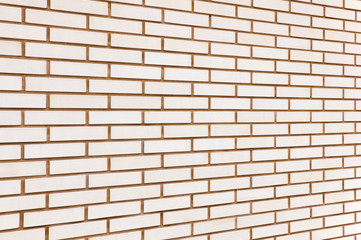 Beige natural fine brick wall texture background perspective