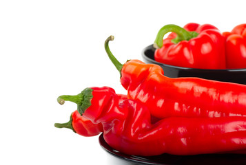 Red peppers in a black plate